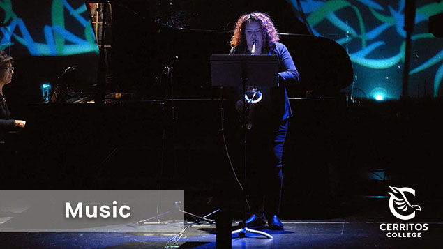 Music student playing a musical instrument on stage