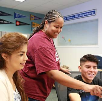 Individual assisting students.